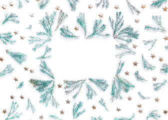 Festive frame made of thuja branches and golden stars on a white background. Template for New Year and Christmas cards, birthday greetings, banner. Flat lat, top view, copy space.