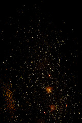 blurry sparks from fireworks on black background