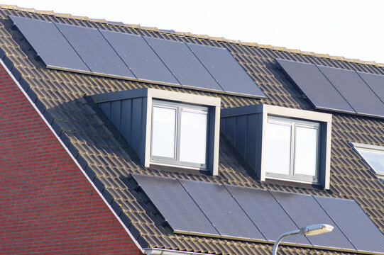 Solar panels on a brown roof with dormer for electric power generation