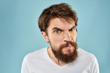 Obraz premium Bearded man emotions facial expression gestures hands close-up blue background