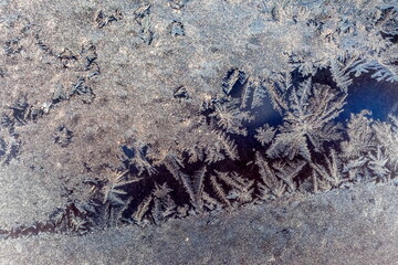 Frosty patterns on window glass in winter