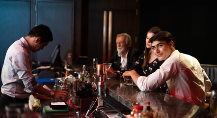 Celebration, Party People concept. Business peoples man and woman Enjoying Evening Drinks in executive bar.