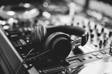Close up of Dj mixes the track in nightclub at party. Hands of dj tweak various track controls on...