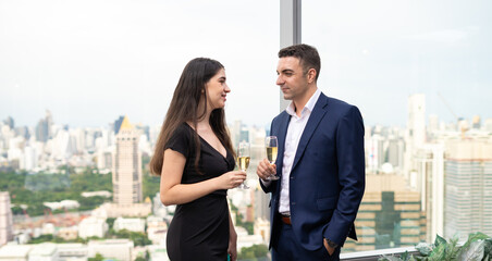 Happy couple with a glass of wine in bar indoors. Young man and woman on date in restaurant