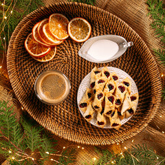 Jam cookies with coffee and milk on a basket