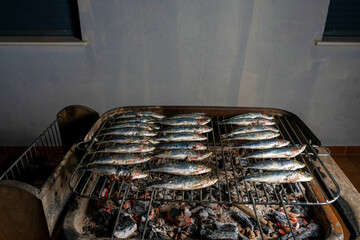 Grilled fresh sardines on a charcoal barbecue