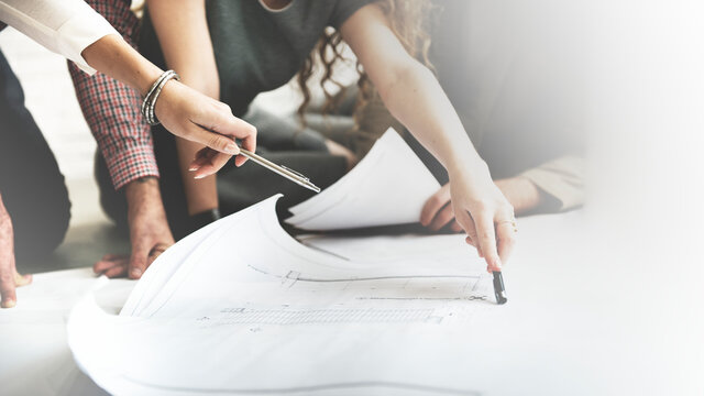 Architects discussing floor plans