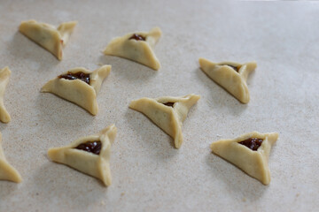 Hamantaschen. (ozenei haman) Triangular pastry made of crispy dough, stuffed with poppy, halva or chocolate. For the Jewish holiday of Purim. Handmade in the middle of preparation, 