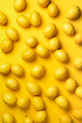 Immune system booster. Fresh lemons pattern on yellow background. Copy space. Top view. Flat lay. Citrus fruits. Vitamins for health. Liposomal vitamin C. Lemon for vegan, vegetarian alkaline diet