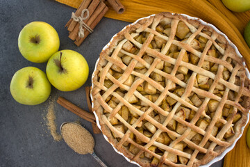 Classic apple pie with lattice decoration. Gray background with copy space. Homemade dessert tart top view photo. 