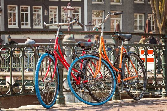 Bikes on the bridge in Amsterdam Netherlands. Classic bicycle parked on canal bridge. Amsterdam cityscape