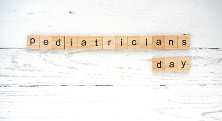 international day of the pediatrician.words from wooden cubes with letters photo