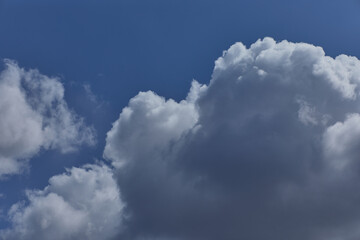 Atmospheric blue sky with cumulated clouds. Background with thick white clouds for Photoshop.
