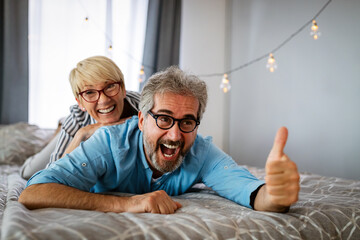 Happy senior couple in love hugging and bonding with true emotions at home