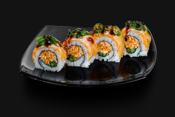 freshly made Japanese sushi rolls served on a black stone slab