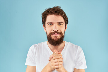 Emotional man with a beard in a white t-shirt blue background fun lifestyle