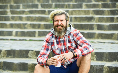 What a great morning. hipster relax on stairs. mature traveler having rest. take away coffee. good morning inspiration. brutal man with beard drinking tea from cup. bearded man drink coffee outdoor