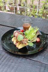 Slice of delicious vanilla cake on wooden table.