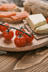 Closeup fresh cherry tomato on a wooden board with other different food
