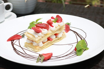 Strawberry Mille Feuille cake in white plate.