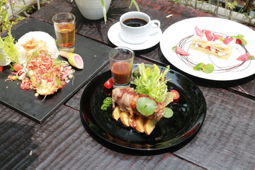 Beef Patty and suki steak in black plate.