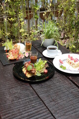 Beef Patty and suki steak in black plate.