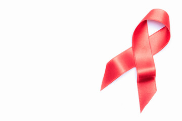 Aid ribbon silk. Red ribbon symbol in hiv world day isolated on white background. Awareness aids and cancer. Flat lay, top view, copy space - obrazy, fototapety, plakaty