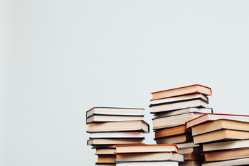 lots of stacks of educational books for exams in the library on a white background