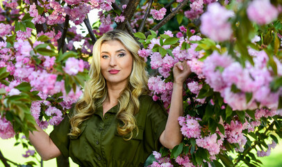 Fototapeta premium Spring blossom. Cherry tree. Good vibes. Floral aroma. Reasons why flowers always make women happy. Perfume and cosmetics. Self care. Happy spring day. Spring symbol. Girl enjoy sakura in garden