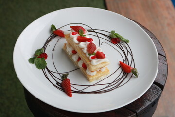 Strawberry Mille Feuille cake in white plate.