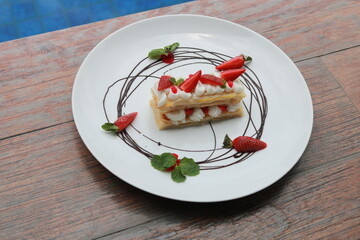 Strawberry Mille Feuille cake in white plate.