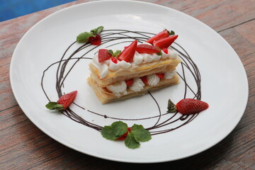 Strawberry Mille Feuille cake in white plate.