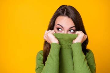 Close-up portrait of pretty curious funny girl hiding face warm sweater creating idea isolated over...