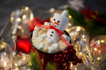 a marshmallow snowman with a red coffee Cup in a close-up Christmas decoration