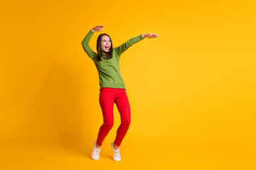 Fototapeta na wymiar Full length body size view of attractive funky cheerful thin girl jumping having fun dancing isolated bright yellow color background