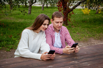 guy with girl with gadgets in the park