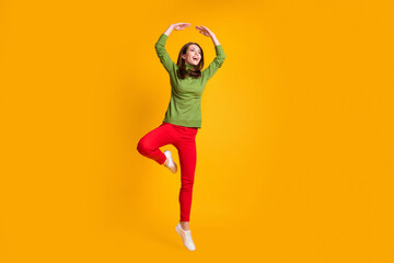 Full length body size view of pretty slender graceful cheerful girl jumping dancing ballet isolated bright yellow color background