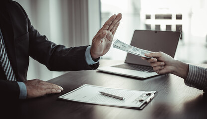 Businessman refuses to receive a bribe.