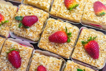 sponge cake with strawberries, a slice of cake on disposable tableware, a biscuit on a background of fruit, vegan and vegetarian cakes