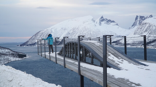 Bergsbotn viewing platform with snow capped mountain peaks and a fjord during winter on Senja Island in Norway.