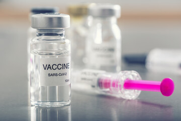 Covid-19 coronavirus vaccine in a ampoule with syringe ready for vaccination