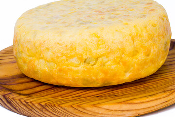 Tasty and big  typical spanish omelette on a wooden tray on white background