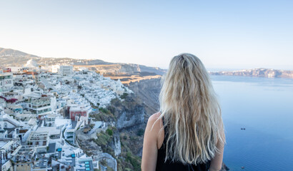 Fototapeta na wymiar A woman admiring a beautiful view of Santorini