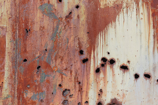 Metal texture with rust, through holes, and paint drips. Horizontal metallic background for design and 3D