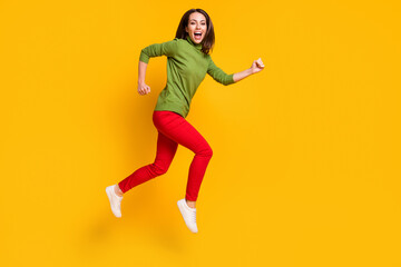 Fototapeta na wymiar Full length profile photo of crazy lady jump up rush wear casual pullover shoes red trousers isolated yellow color background