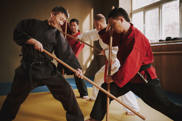 A man in kimono blocks while he protects himself. 