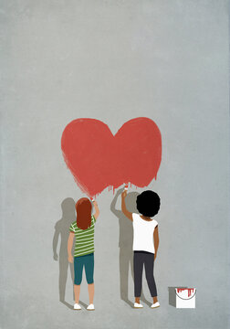 Multiethnic girls painting red heart on wall
