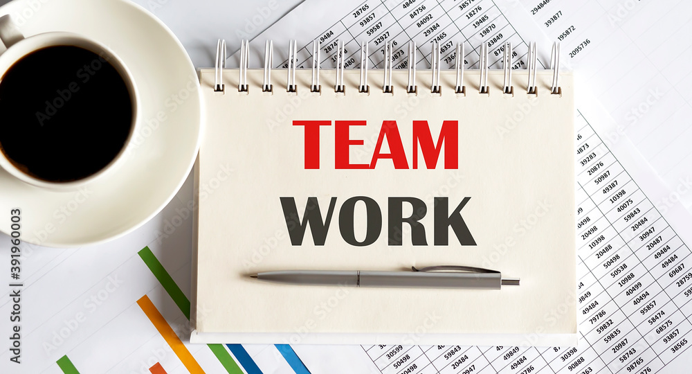 Poster team work text written on a notebook with pen and chart