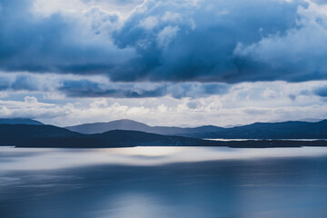 picturesque view on sea coastline and cloudy sunset sky