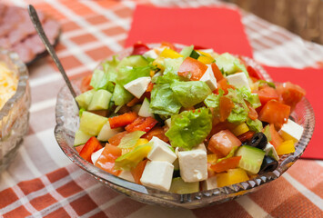 Salad in a crystal vase on the background of the tablecloth